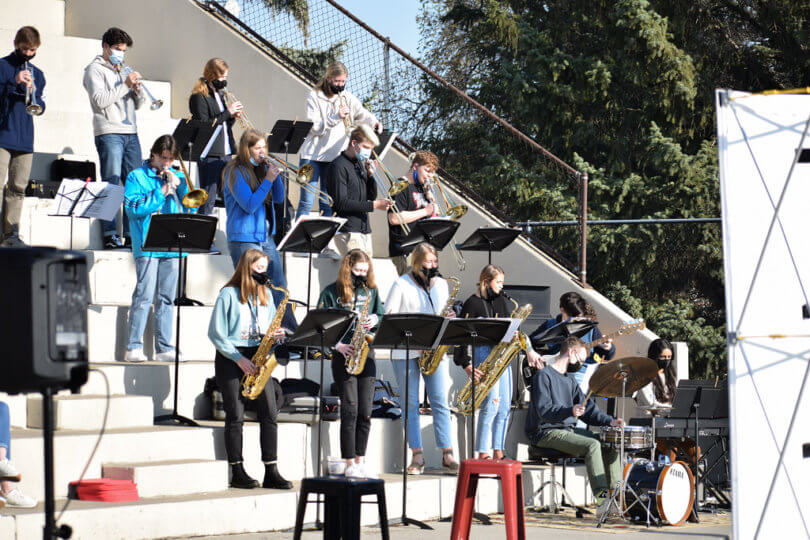 band playing on white staircase